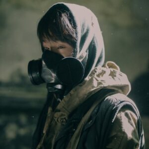 person in black and white hoodie wearing black gas mask