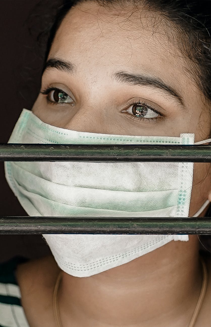 woman wearing face mask crying