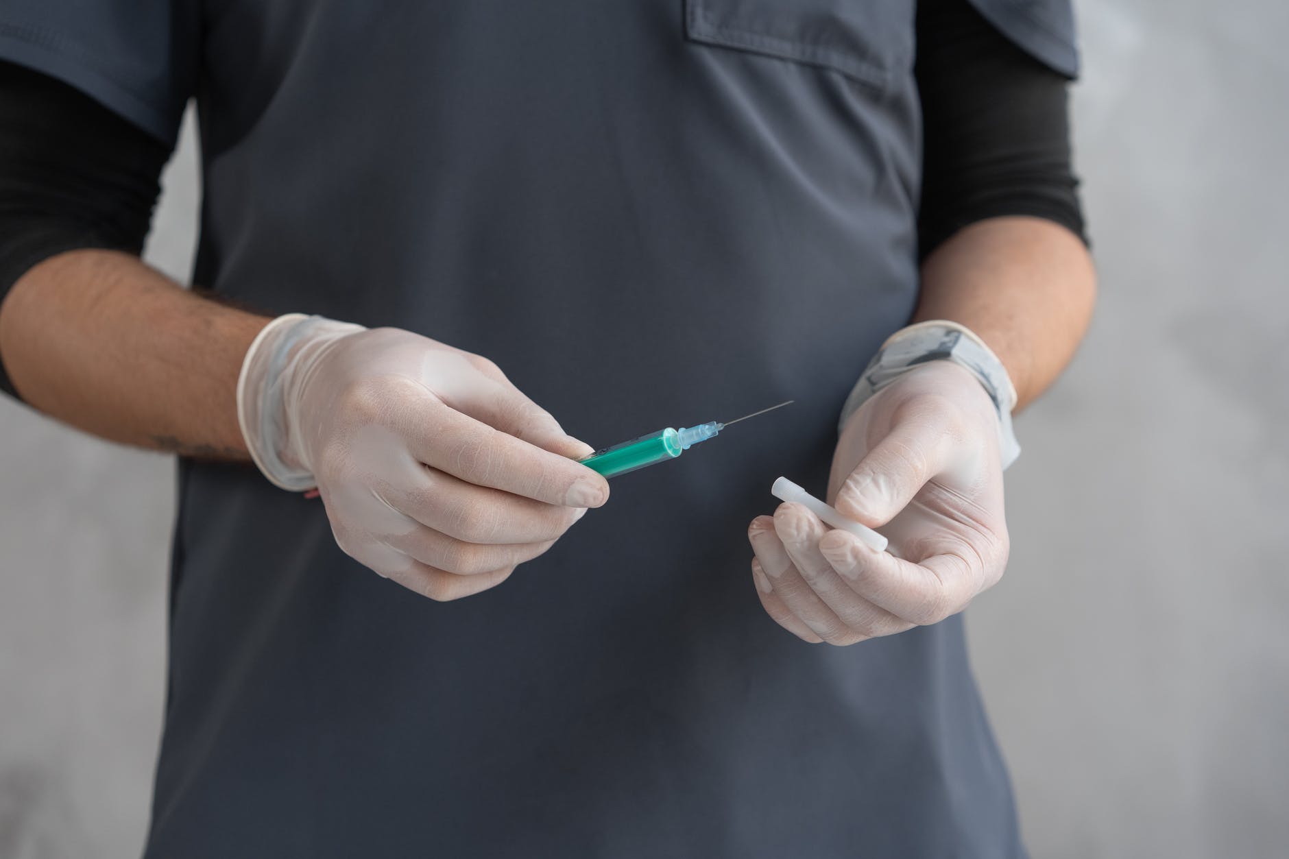 person in black shirt holding green and white pen