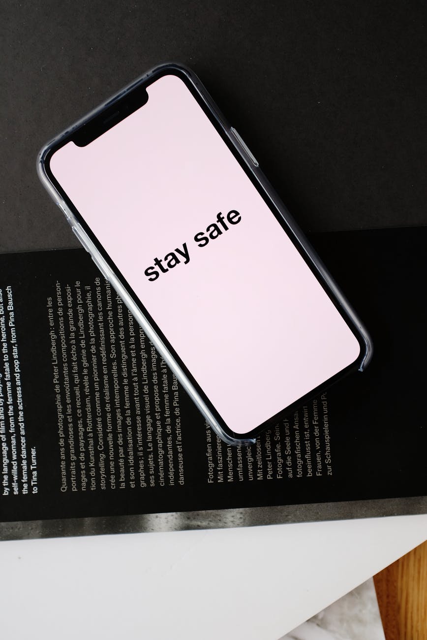 smartphone with stay safe title on open magazine