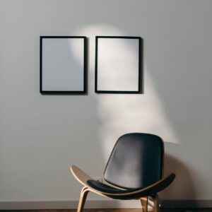 black wooden framed black padded armchair