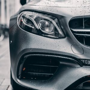 half of gray car placed on city street