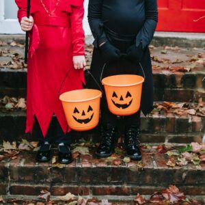 children holding a halloween design buckets