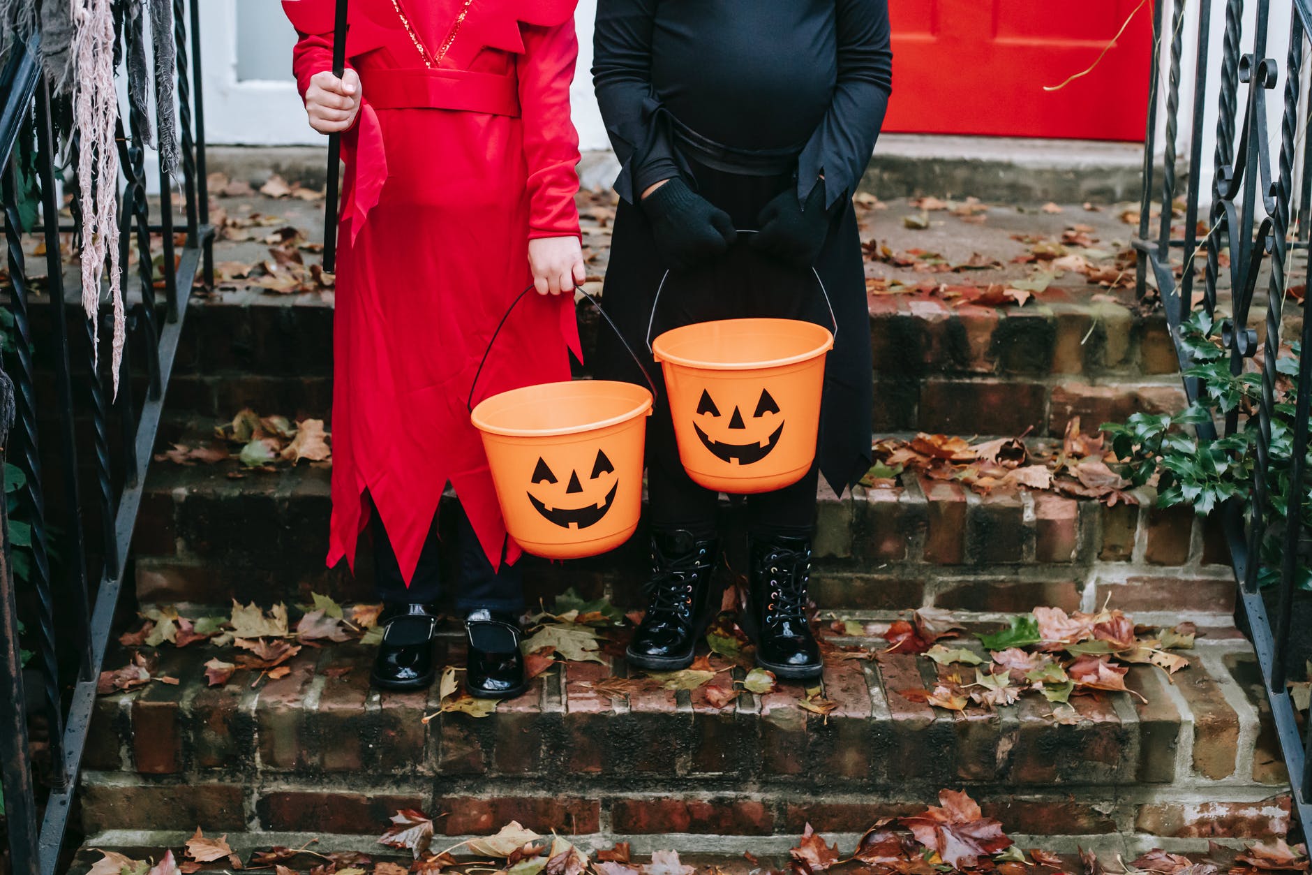 children holding a halloween design buckets