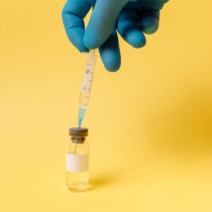 covid vaccine on yellow surface