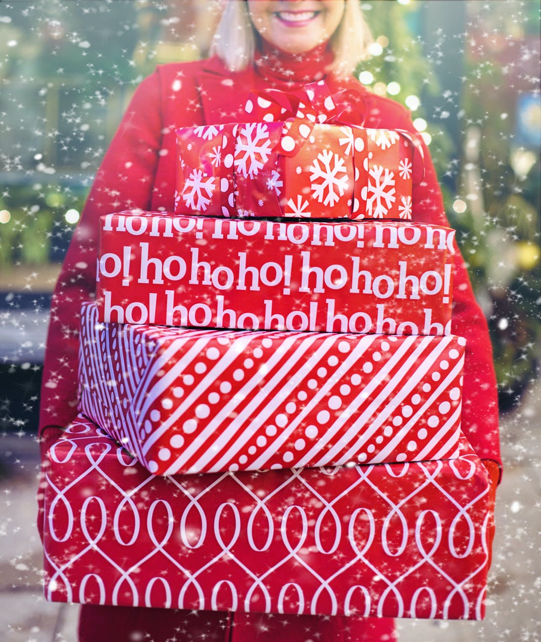 woman carrying christmas gifts