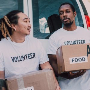 men in crew neck shirt carrying boxes
