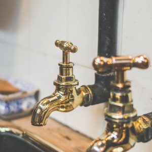 close up photo of golden faucets
