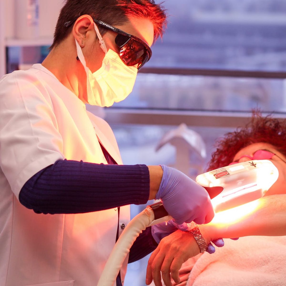 woman giving laser treatment