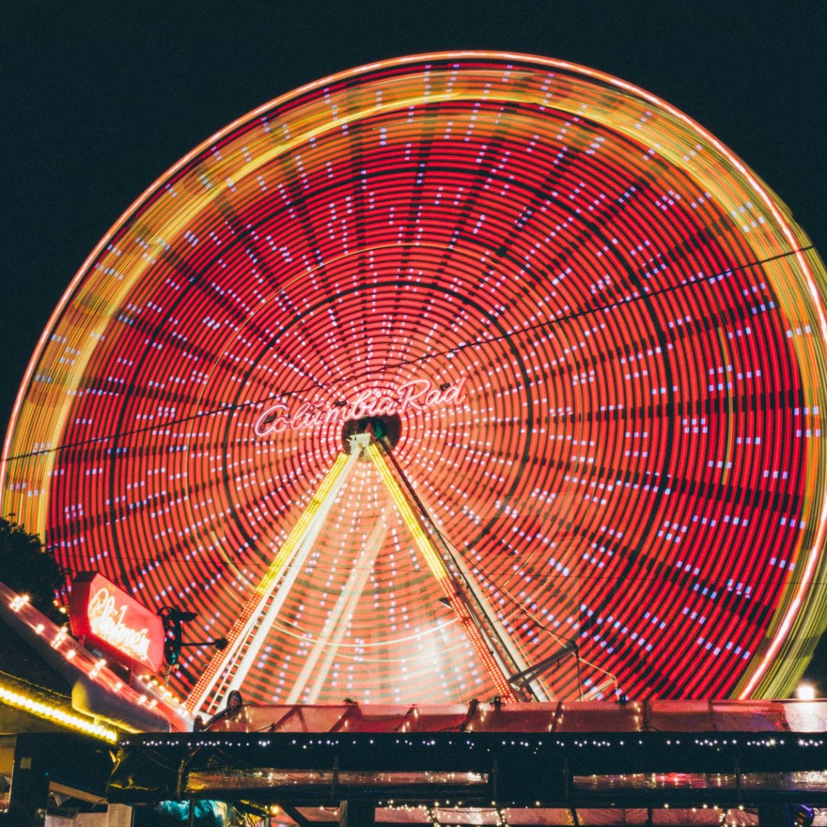 time lapse photo of red and yellow lighted ferris wheel