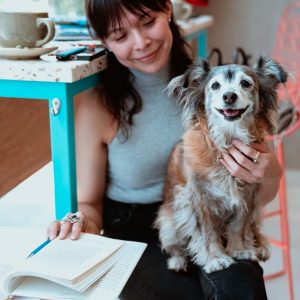 a woman holding her pet dog
