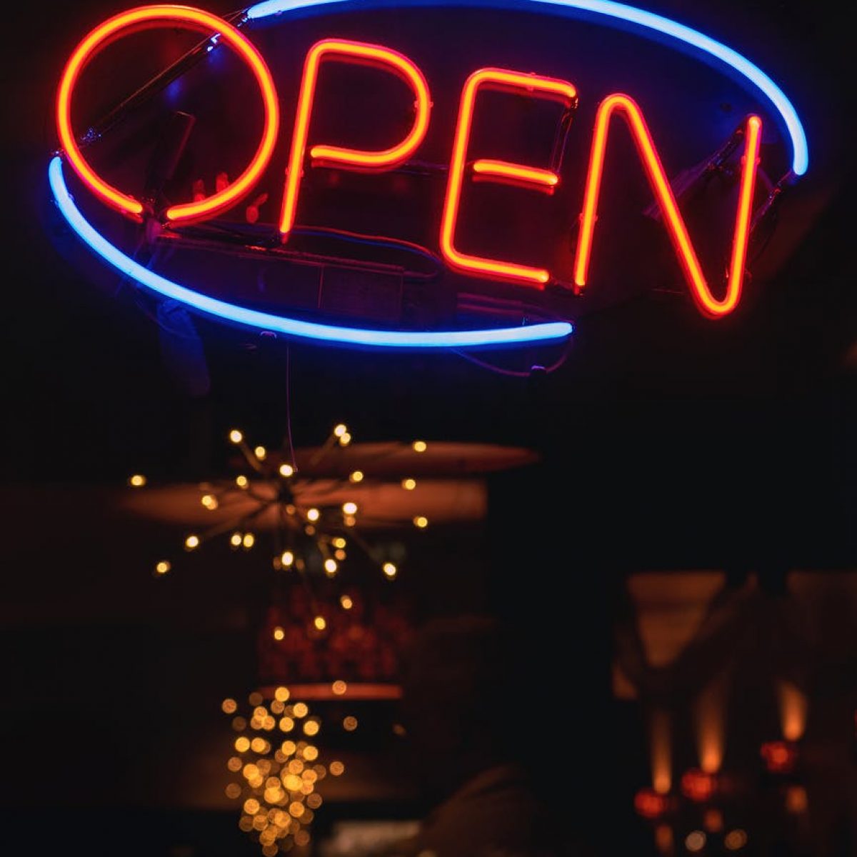 oval blue and orange open neon signage turned on