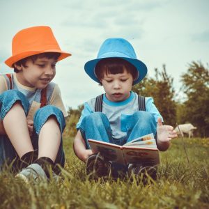 kids sitting on green grass field