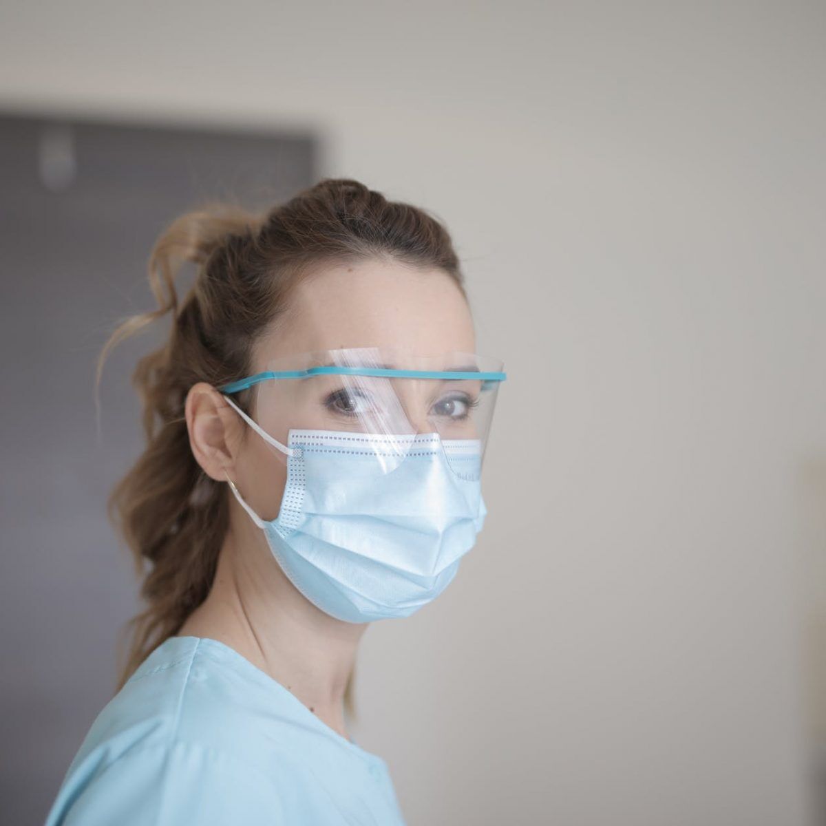 woman in blue shirt wearing face mask