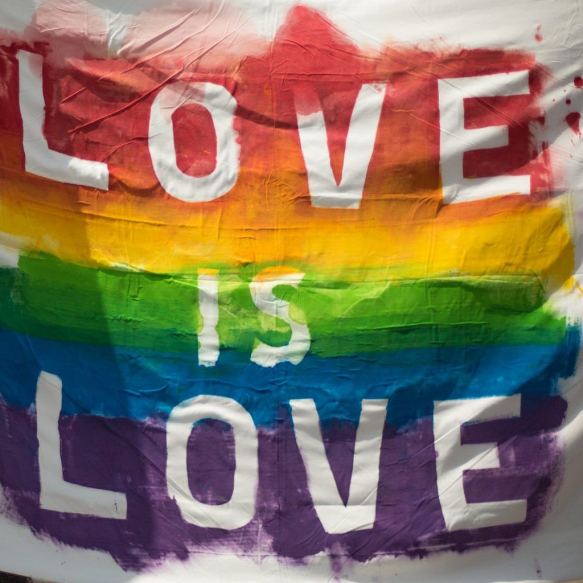 white and multicolored love is love banner