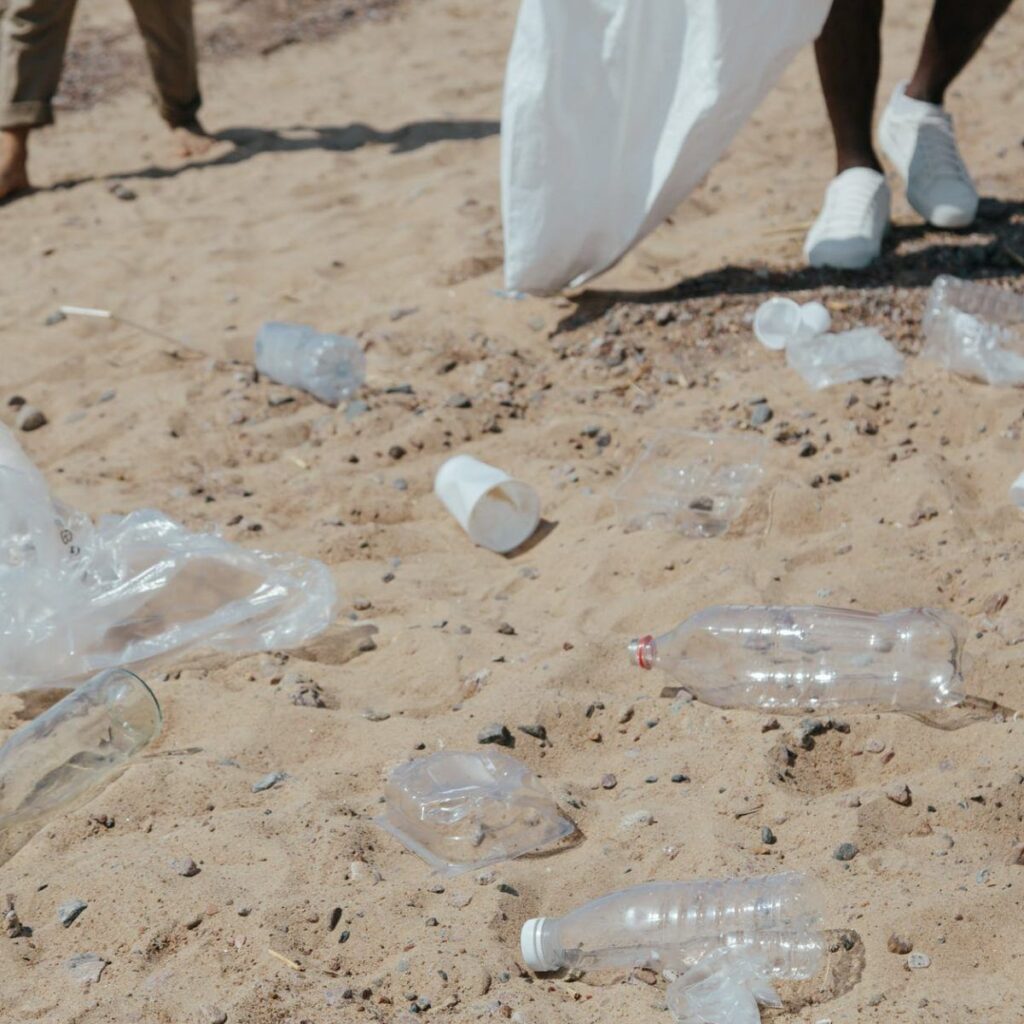 plastic bottles and plastic bags on sand