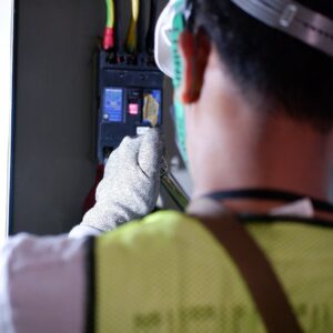 a man working on an electric switch breakers
