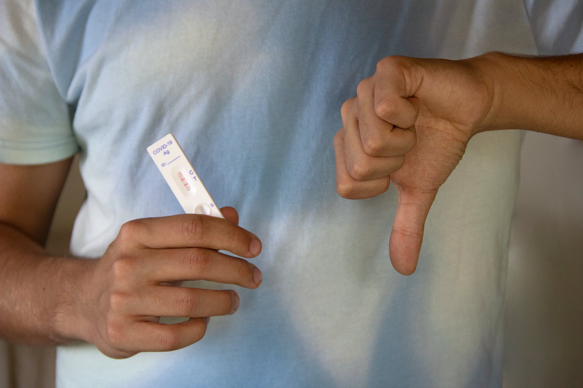 a person holding an antigen rapid test result