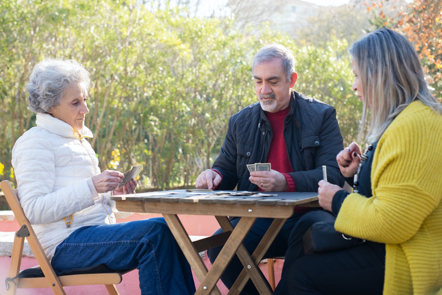 elderly people playing cards