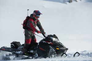 Person riding a snowmobile.