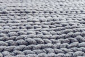 close up of gray cable knit cloth