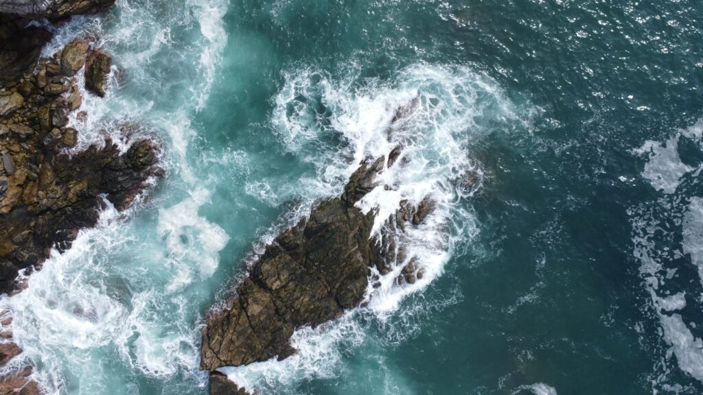 An aerial view of the ocean and rocks