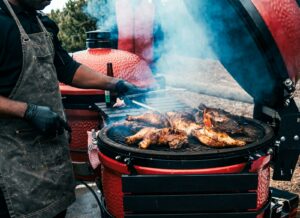 a person grilling meat on a grill