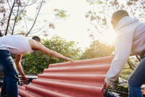 woman in white tank top and white pants standing beside red curtain during daytime
