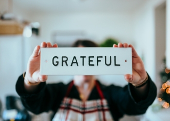 person holding white and black i love you print card