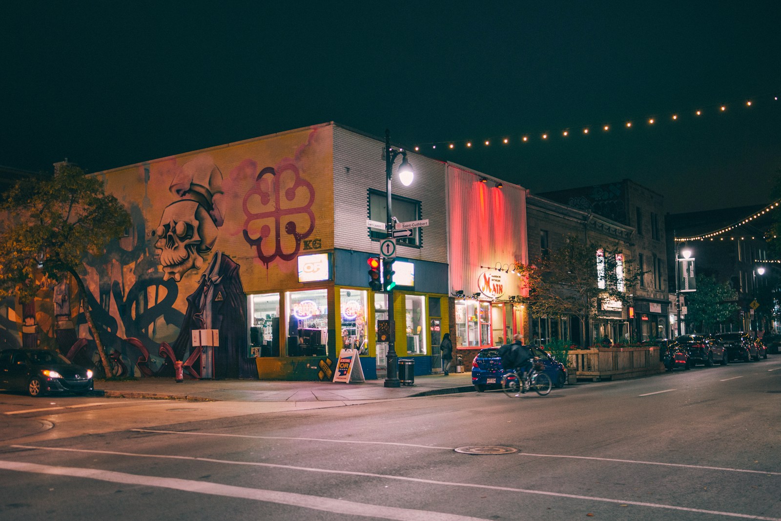 blue vehicle parked beside road during nighttime