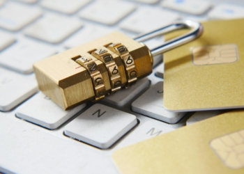 a golden padlock sitting on top of a keyboard