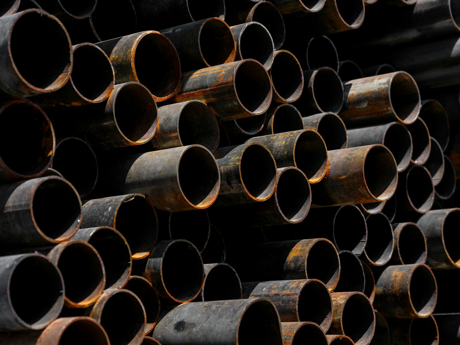 A large stack of pipes stacked on top of each other