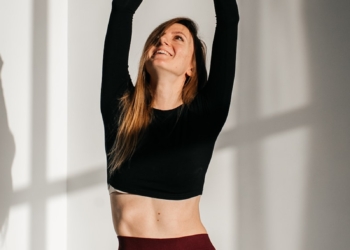 a woman in a black top and maroon pants