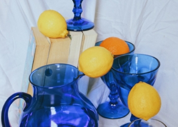 blue glass pitcher with lemon fruits