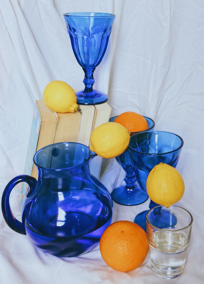 blue glass pitcher with lemon fruits