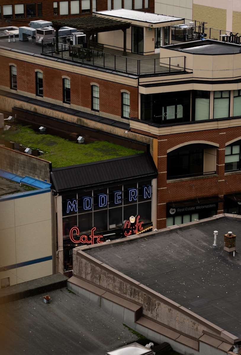 Modern cafe sign on brick building rooftop