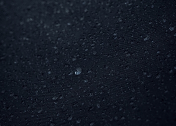 a close up of water droplets on a black surface